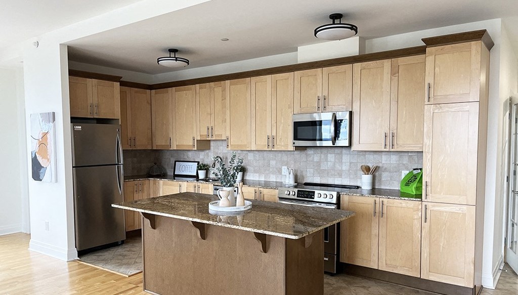 a large kitchen with wooden cabinets and stainless steel appliances