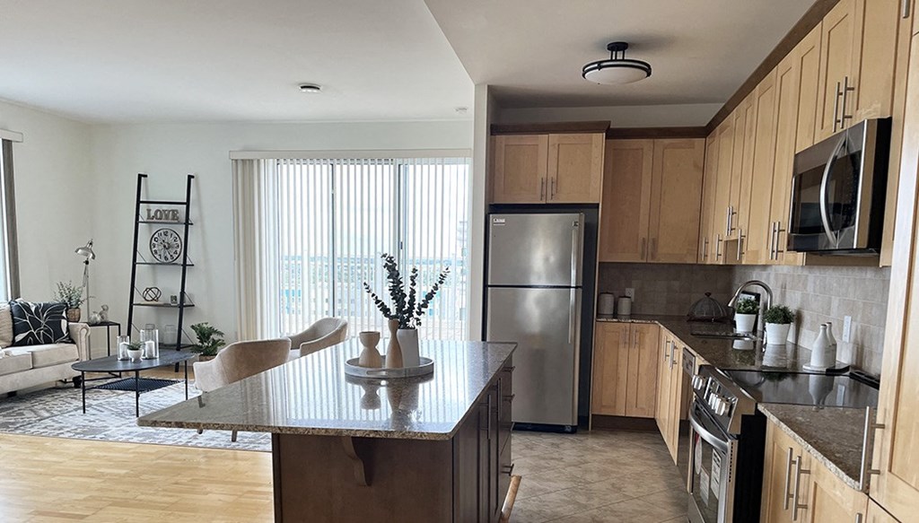 a kitchen with stainless steel appliances and a island in the middle