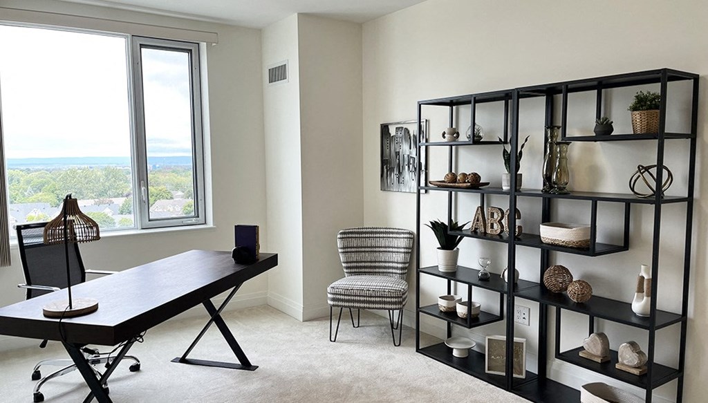 a home office with a desk and a window