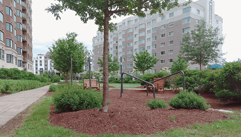 a playground in a park next to an apartment building