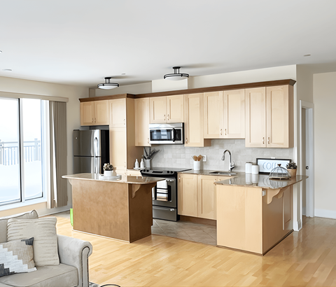 A modern kitchen with wooden cabinets and stainless steel appliances.
