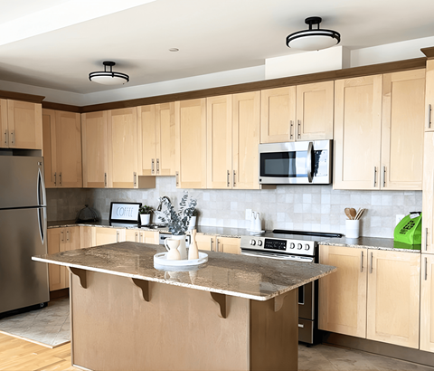 A kitchen with wooden cabinets and a granite countertop.