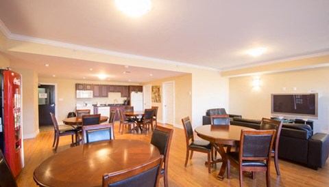A living room with a wooden table and chairs.