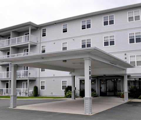 A large building with a covered walkway in front.