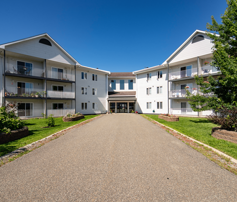 A sunny day at the apartment complex with a clear blue sky.