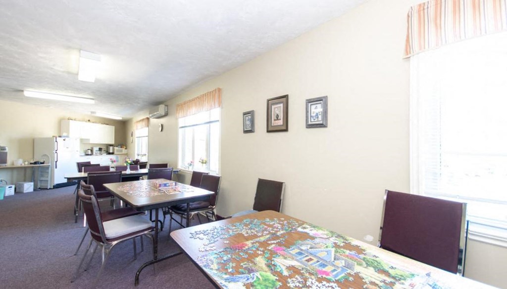 a dining room with a table and chairs