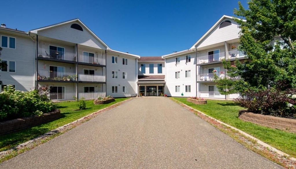 a view of an empty street between two apartment buildings