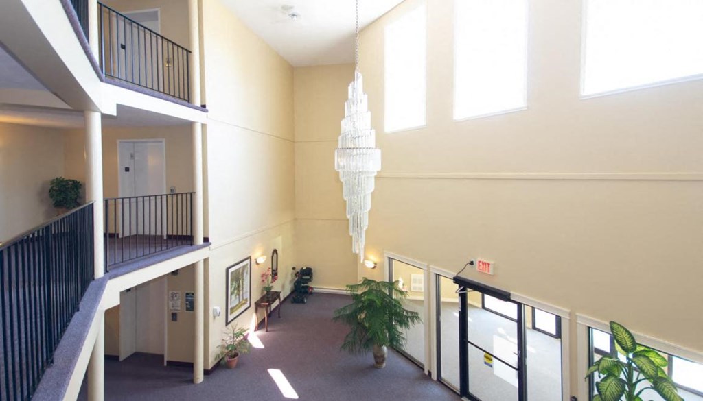 a view of the lobby of a building with a chandelier