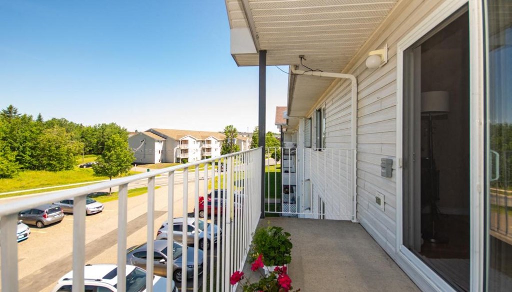 a balcony with a view of a parking lot