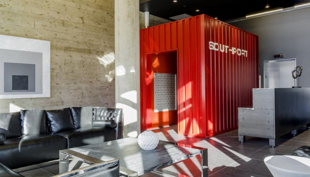 a large red shipping container in the middle of a living room