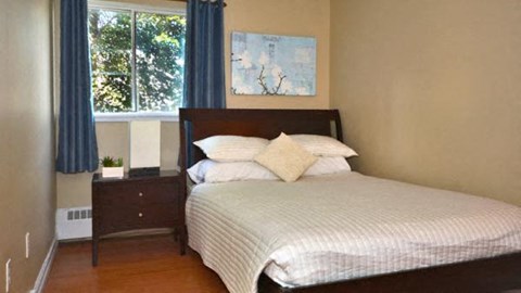 a bedroom with a bed and a window