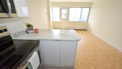 a kitchen with a counter top and a window