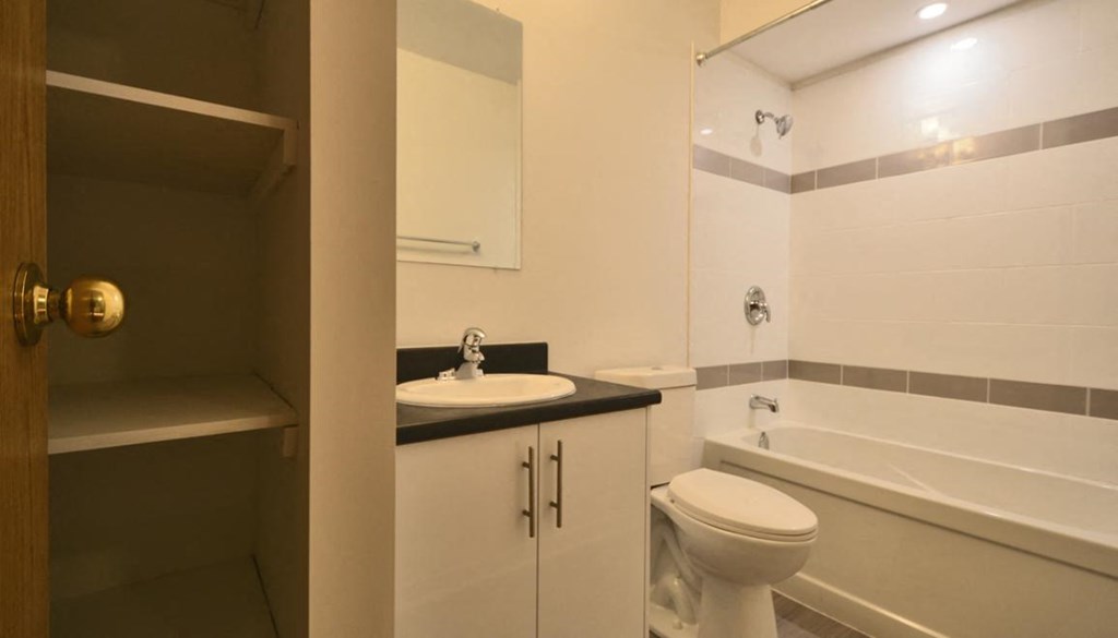 a bathroom with a sink toilet and a bath tub