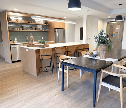 A modern kitchen with a dining table and chairs.