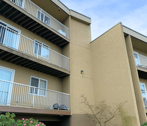 A building with beige walls and white railings.