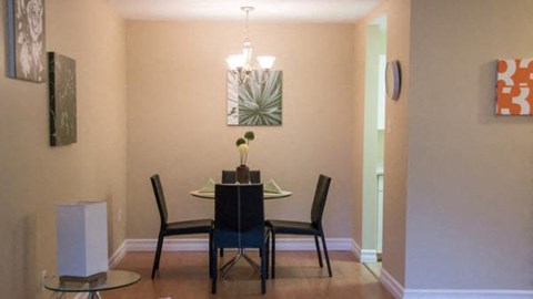 a dining room with a table and chairs