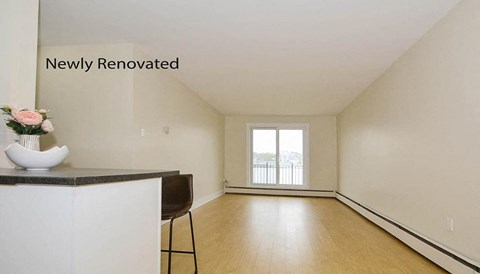 A newly renovated room with a marble countertop and a chair.