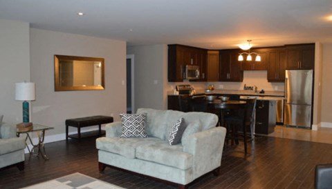 a living room with a couch and a kitchen