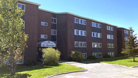 A brick building with a sign that says "SJB Leadership Center".