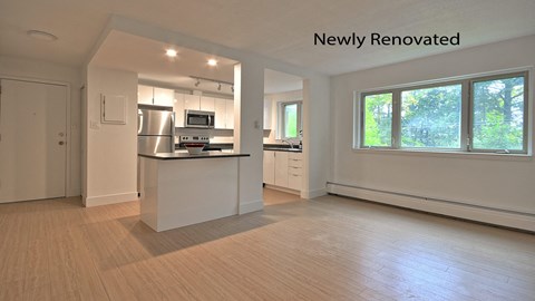 an open kitchen with a island and a large window