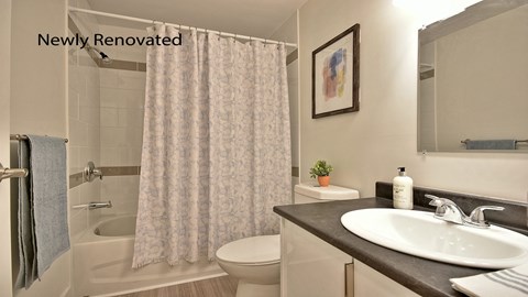 an image of a bathroom with a sink toilet and shower