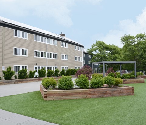 A building with a green lawn in front of it.