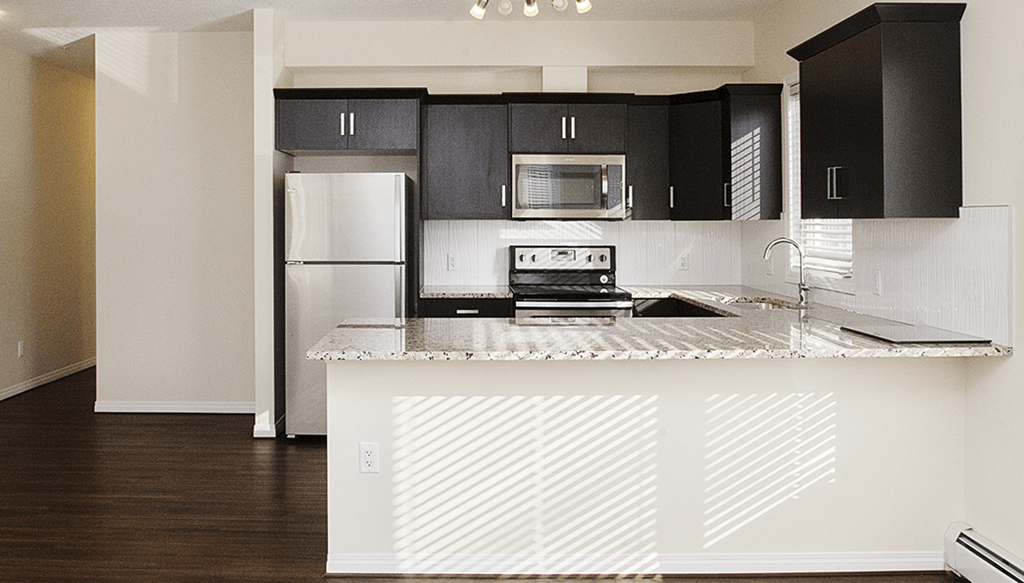 a kitchen with a counter top and a refrigerator