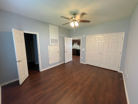 a living room with hardwood floors and a ceiling fan