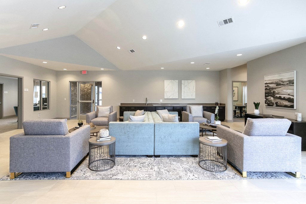 a living room filled with furniture and a large window