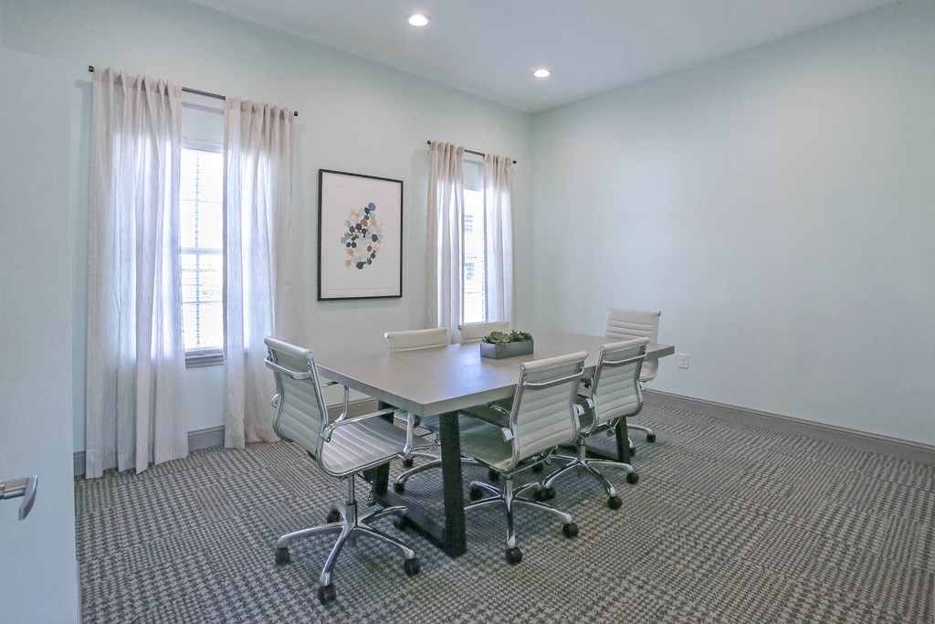 a conference room with a table and chairs