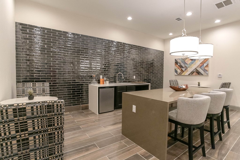 a kitchen with a large island and a breakfast bar