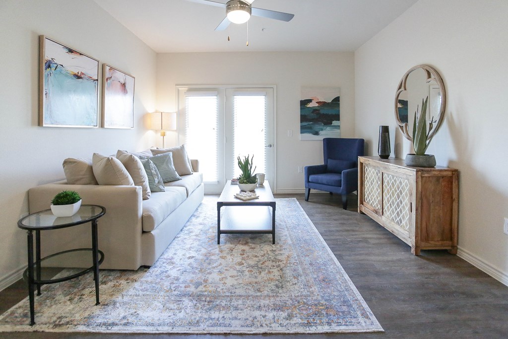 a living room with a white couch and a blue chair