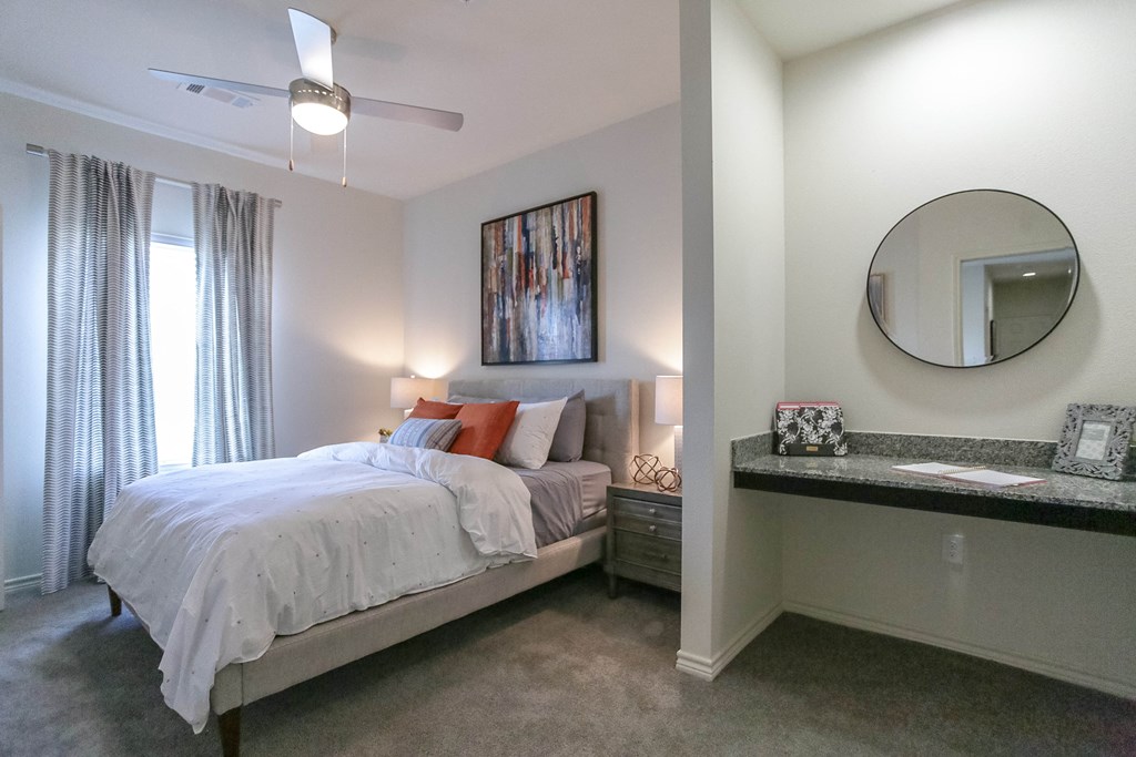a bedroom with a bed and a mirror