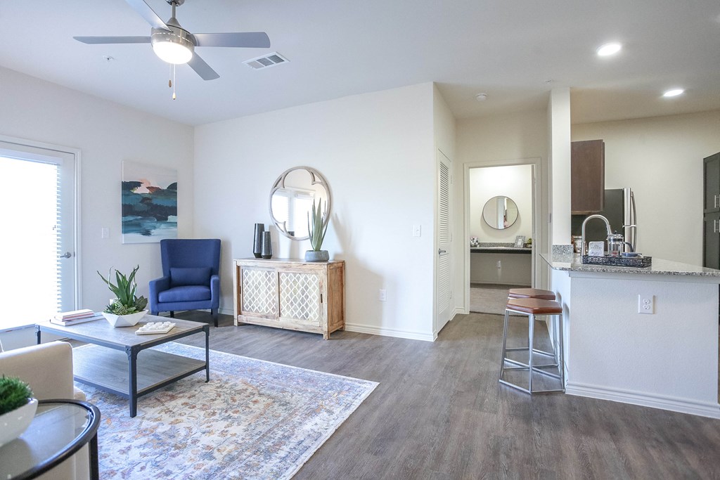a living room with a kitchen in the background