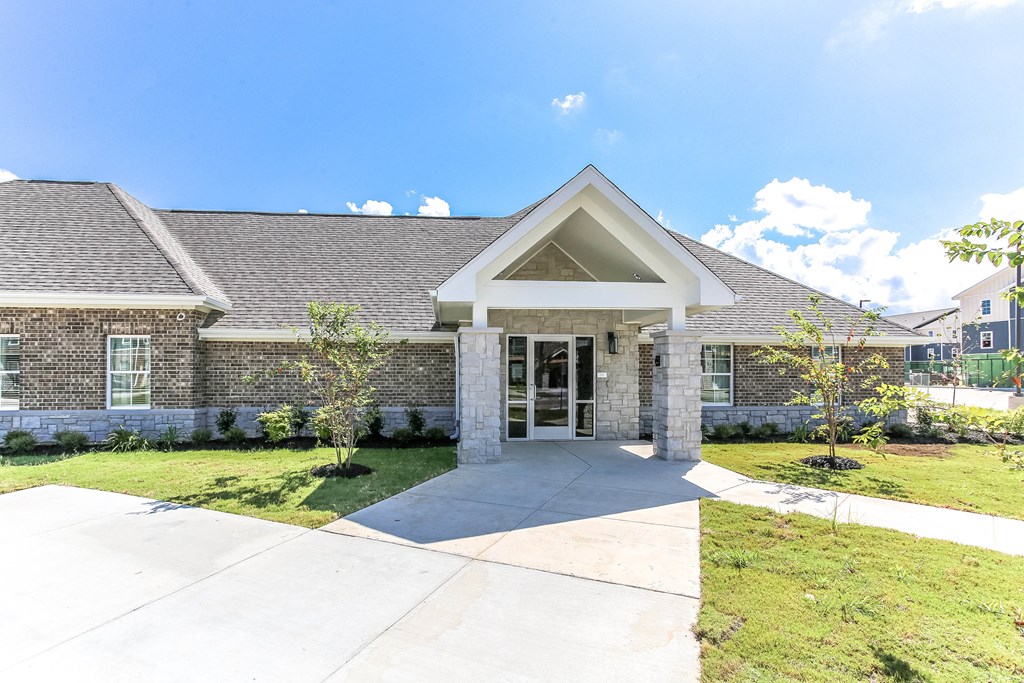 a large brick house with a gray roof