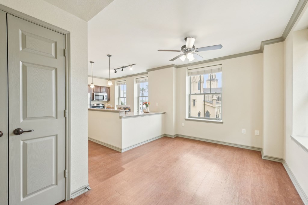 A room with a ceiling fan and a door.