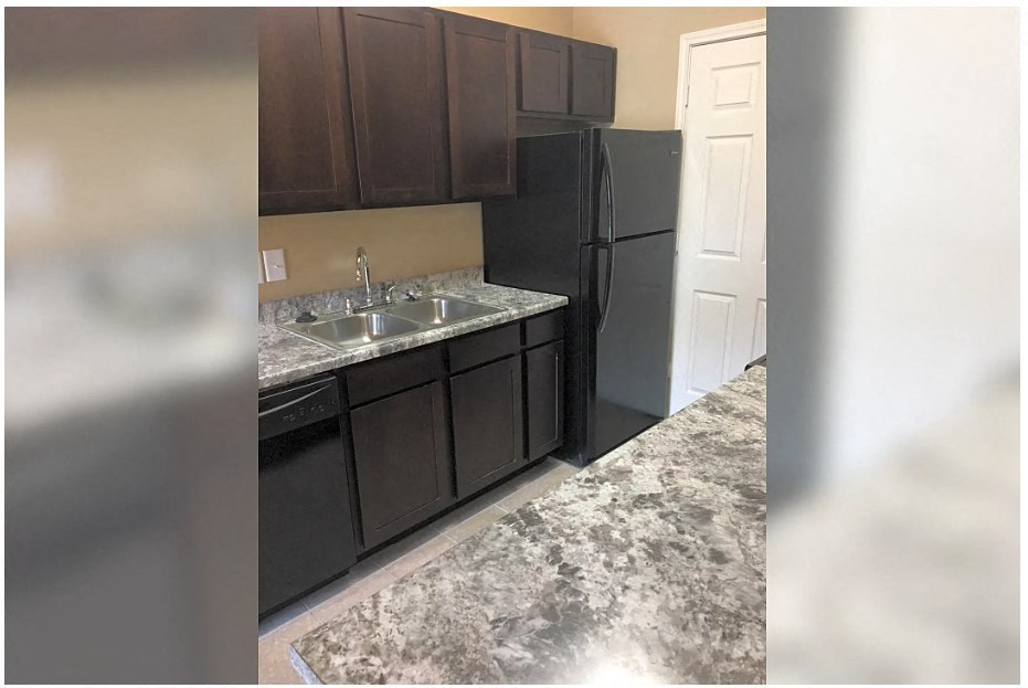a kitchen with a sink and a refrigerator