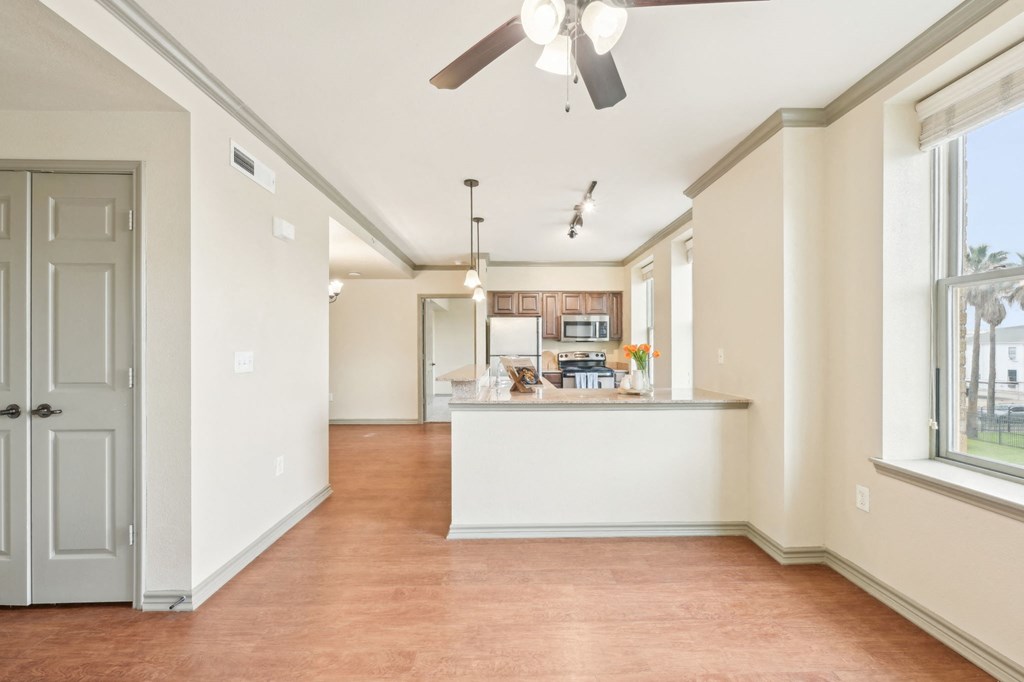 A room with a white counter and a ceiling fan.