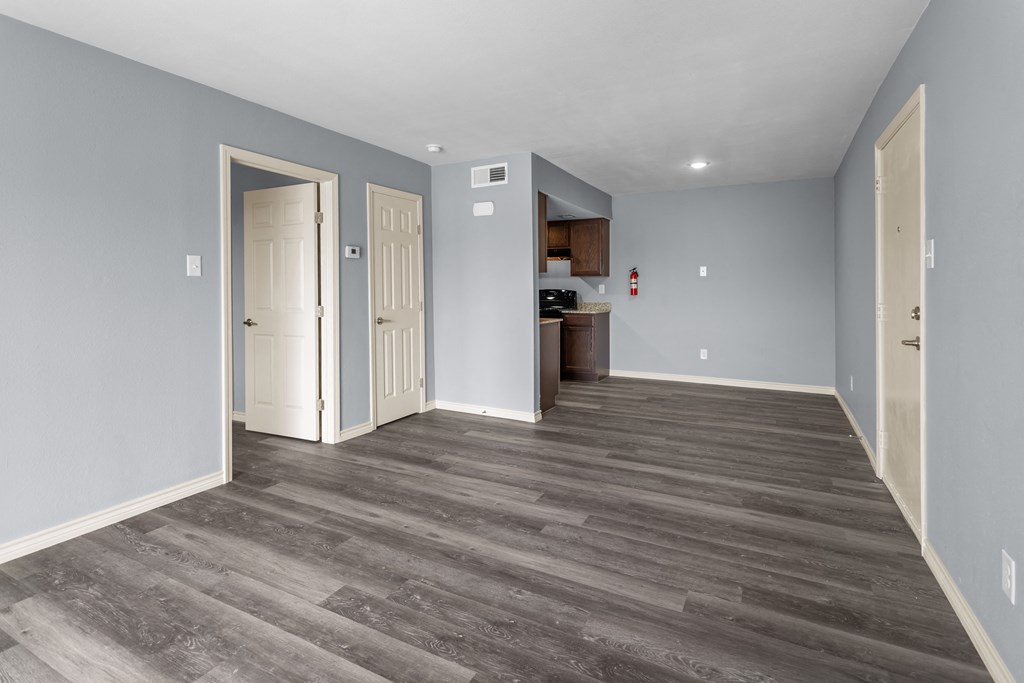 a bedroom with hardwood floors and grey walls