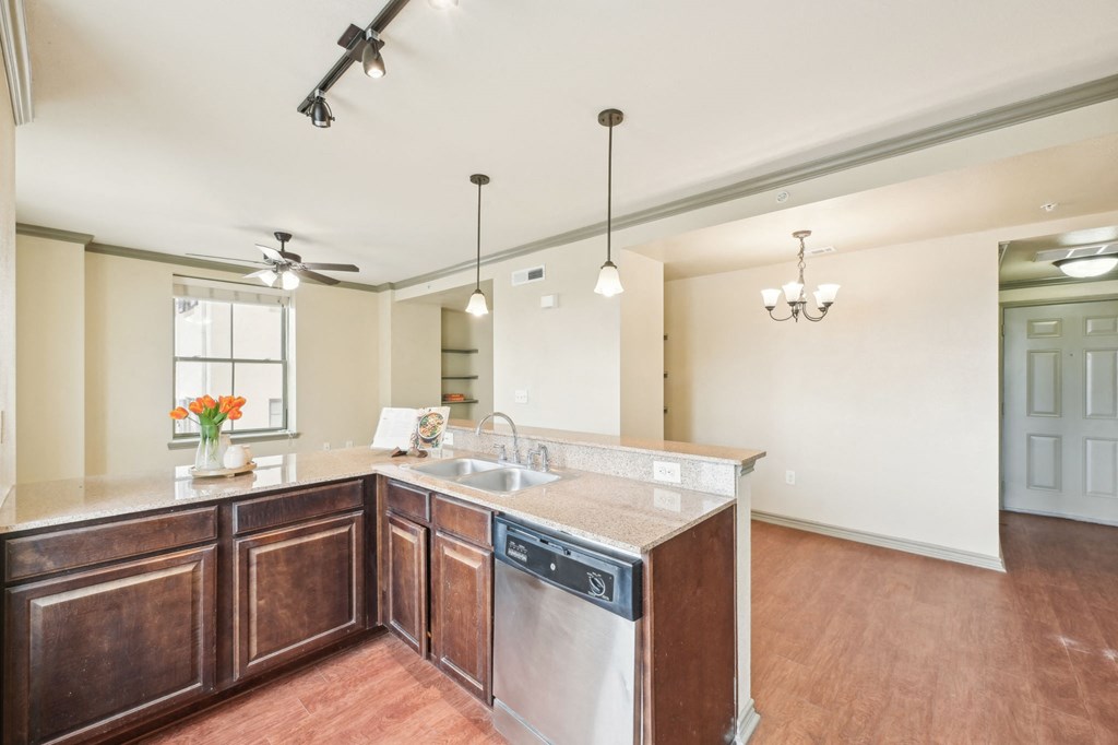 A kitchen with a wooden counter and a dishwasher.