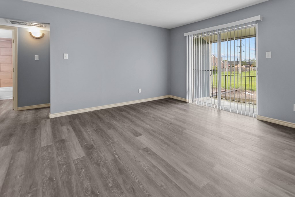 the spacious living room in a bedroom plus den unit at the whispering winds apartments in pearland