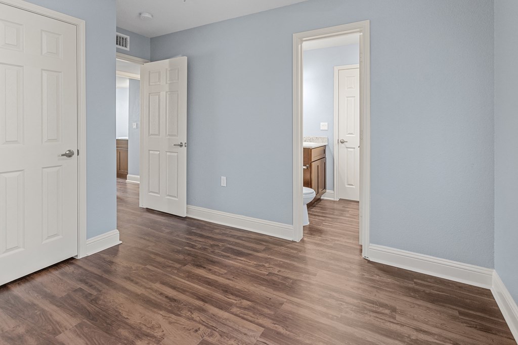 a renovated living room with blue walls and wood floors
