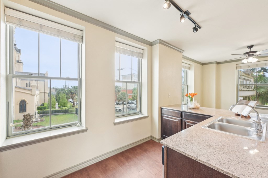A kitchen with a sink, a window, and a ceiling fan.
