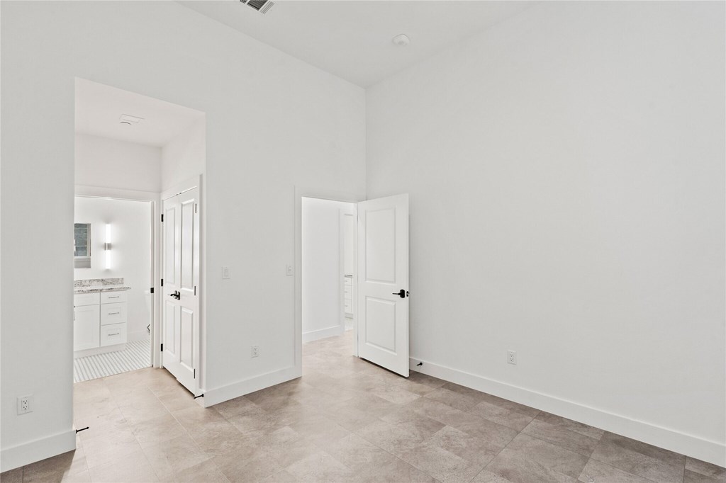 A white room with two open doors.