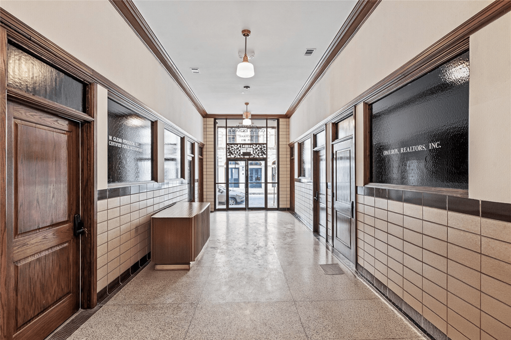 A hallway with a bench and a sign that says "Keller Realty Inc."