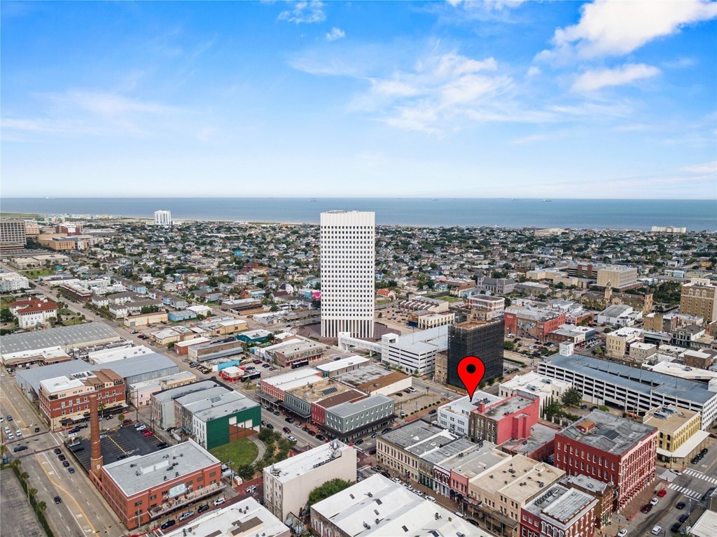 A cityscape with a red pin marking a specific location.