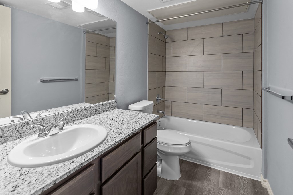 a bathroom with a sink toilet and bathtub