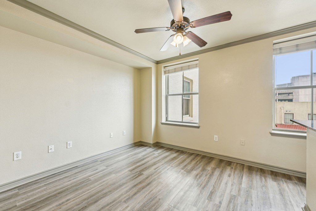 A room with a ceiling fan and a window.