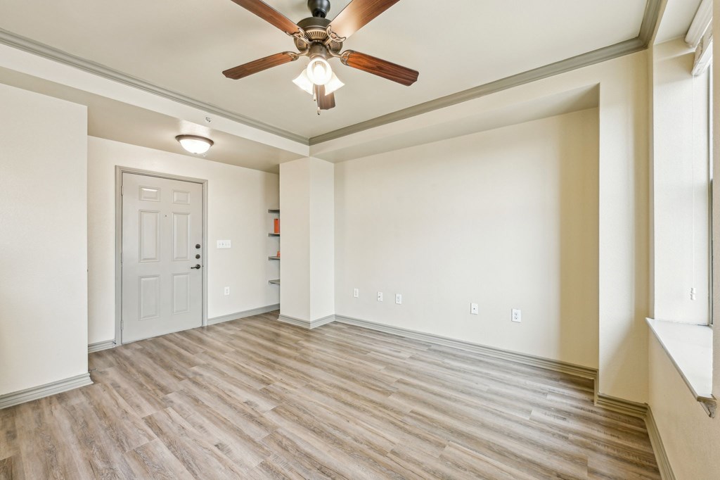 A room with a ceiling fan and light fixture.