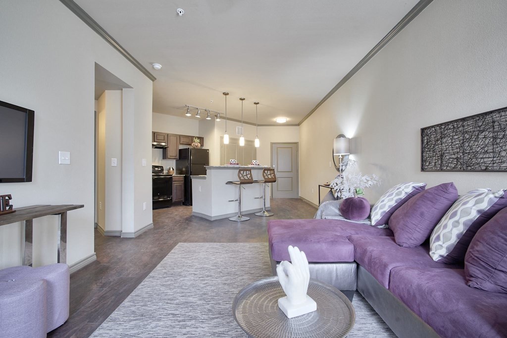 a living room filled with furniture and a large window